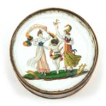 AN EARLY 19TH CENTURY FRENCH POWDER BOX having an enamelled circular lid depicting two ladies in