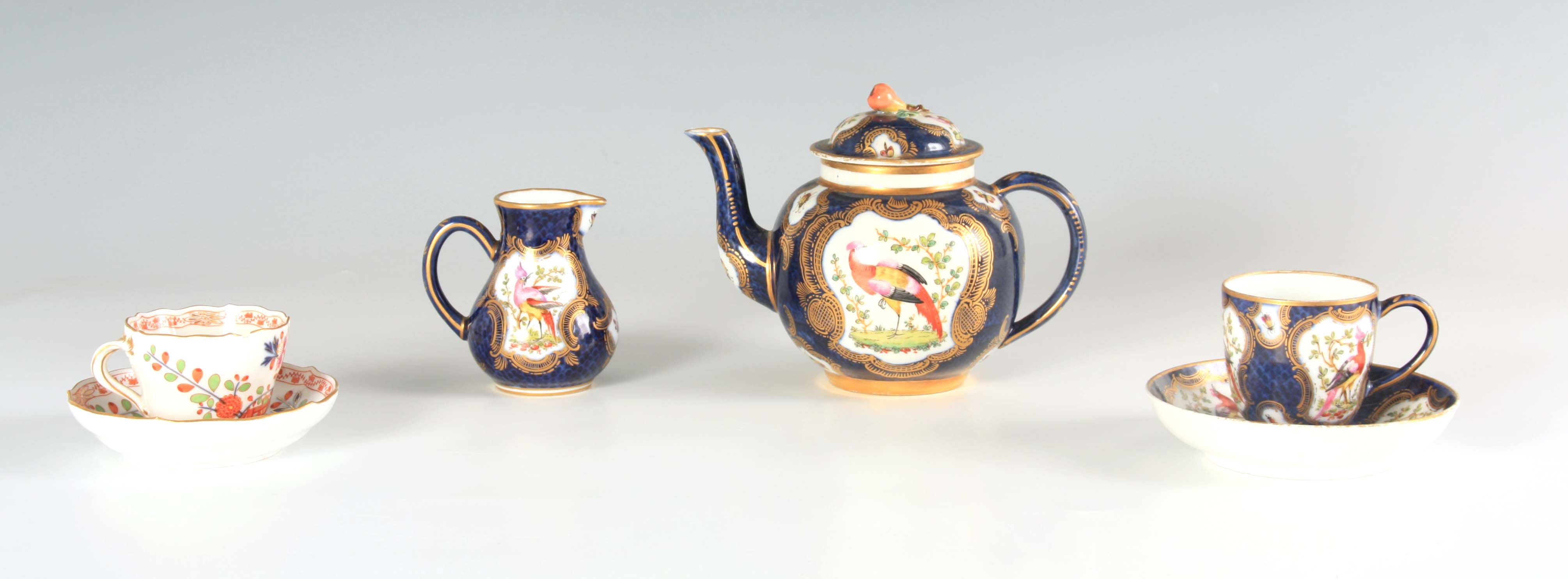 A FIRST PERIOD WORCESTER TYPE THREE PIECE SOLITAIRE SERVICE comprising a bulbous teapot with fruit