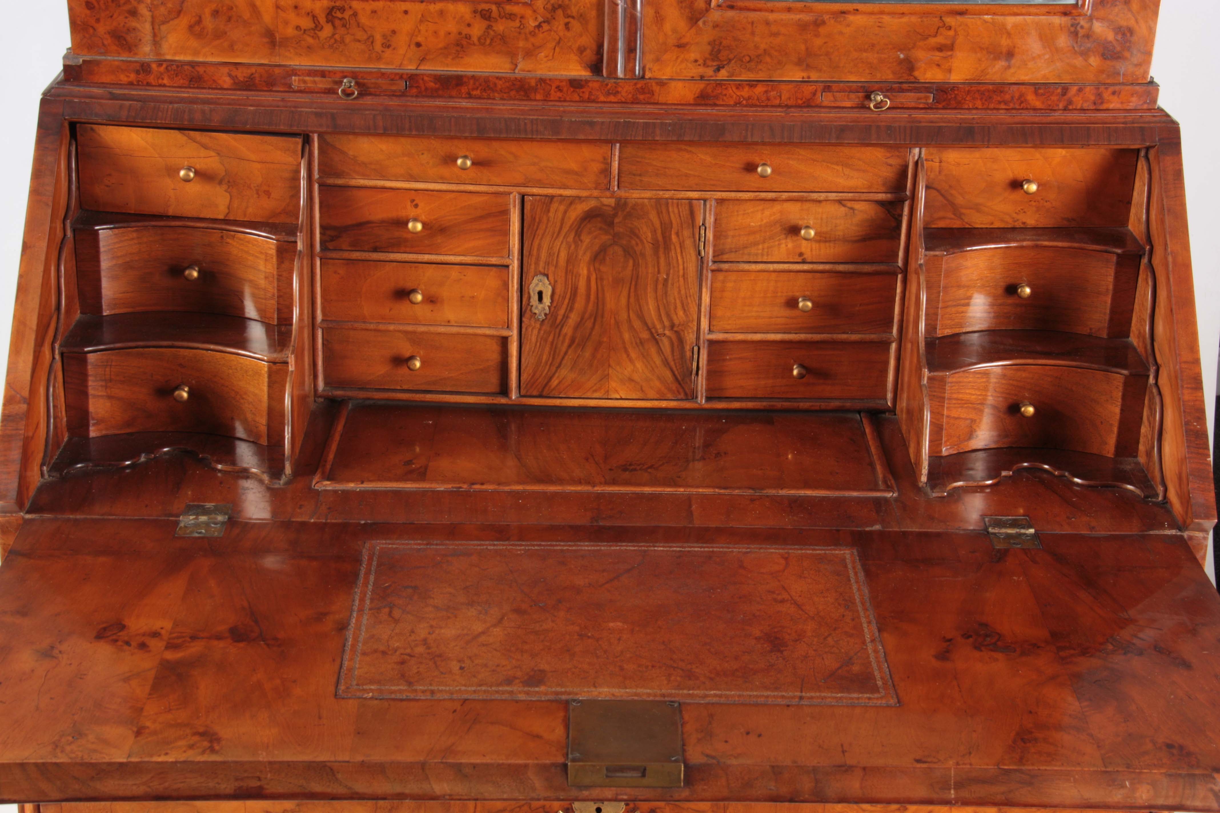 A WILLIAM AND MARY BURR WALNUT BUREAU BOOKCASE with broken arch pediment above shaped mirrored doors - Image 8 of 14
