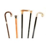 A COLLECTION OF FIVE WALKING CANES a horn and mother-of-pearl handled Malacca walking stick 84.5cm
