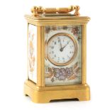 AN EARLY 20TH CENTURY FRENCH MINIATURE PORCELAIN AND ENAMEL PANELLED CARRIAGE CLOCK with gilt