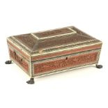 A REGENCY ANGLO-INDIAN WORKBOX of sarcophagus form with finely carved sandalwood panels framed