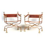 A PAIR OF SPANISH 19TH CENTURY PAINTED CAST IRON AND BRASS X FRAMED FOLDING ARMCHAIRS WITH TANNED