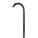 A 19TH CENTURY RHINO HORN WALKING STICK with simulated branchwork shaft, having a crook handle