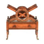 A WILLIAM IV ROSEWOOD CANTERBURY with X frame divisions and leaf carved circular front; above a