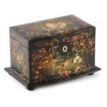A 19TH CENTURY PAPIER MACHE TEA CADDY decorated with flowers and gilt decoration, the hinged top