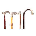 A SELECTION OF FOUR EARLY 20TH CENTURY FRENCH SILVER METAL AND NICKEL PLATED WALKING STICKS with