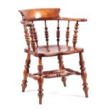 A 19TH CENTURY ELM SMOKERS BOW ARMCHAIR with hopped armrest and raised back supported by turned