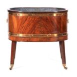 A GEORGE III FLAMED MAHOGANY BRASS BOUND WINE COOLER OF OVAL FORM with ogee cross moulded top edge