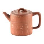 A 19TH CENTURY TERRACOTTA EARTHENWARE CHINESE TEAPOT with lid and inner strainer, decorated with