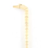 A 19TH CENTURY MARINE IVORY WALKING STICK with simulated vertebrate shaft and ducks head handle 95cm