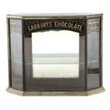 A VICTORIAN CADBURYS CHOCOLATE SHOP DISPLAY CABINET of angled shape with nickel moulded mouldings