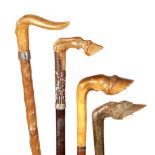 A SELECTION OF FOUR LATE 19TH/EARLY 20TH CENTURY RHINO HORN HANDLED WALKING STICKS SHAPED AS