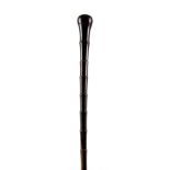 A 19TH CENTURY HORN WALKING STICK with ring turned pommel 86.5cm overall.