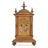 A LATE 19TH CENTURY FRENCH GILT BRASS AND PORCELAIN PANELLED MANTEL CLOCK the moulded case with