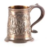 A GEORGE III SILVER MUG BY JOHN LANGLANDS, NEWCASTLE of tapering form embossed with floral