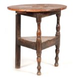 AN 18TH CENTURY PRIMITIVE BLEACHED CHESTNUT AND PINE CRICKET TABLE with circular plank top above a