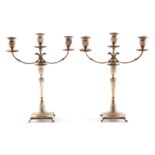 A PAIR OF CONTINENTAL SILVER EMPIRE STYLE THREE BRANCH CANDELABRA with reeded sconces and eagle head