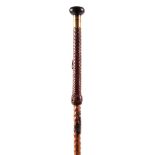 A 19TH CENTURY EUROPEAN SPIKE STICK with black hawthorn shaft and leather twisted handle, having a