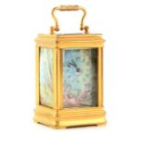 AN EARLY 20TH CENTURY FRENCH MINIATURE PORCELAIN PANELLED CARRIAGE CLOCK the gilt brass canalee case