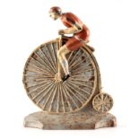 A RARE 19TH CENTURY CAST IRON PAINTED DOORSTOP FORMED AS A CYCLIST MOUNTED ON A PENNY FARTHING,
