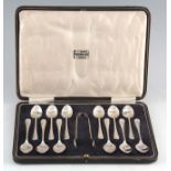 A GEORGE V CASED SET OF TWELVE TEASPOONS AND TONGS by Roberts and Belk, Sheffield, 1927, 220 grams.