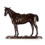 A MEIJI PERIOD JAPANESE BRONZE SCULPTURE OF A SADDLED HORSE on a naturalistic base with rounded ends