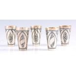 A SET OF FIVE RUSSIAN SILVER NIELLO VODKA CUPS of tapering form with engraved black enamel