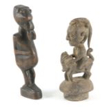 TWO AFRICAN CARVED HARDWOOD SCULPTURES 24cm and 22cm high