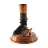 A LATE 19TH CENTURY CARVED TREEN MATCHSTICK HOLDER formed as a boot and pivoting boot jack, 12cm