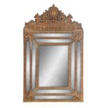 A LARGE 19TH CENTURY PRESSED BRASS CONTINENTAL HANGING MIRROR with floral embossed crest above