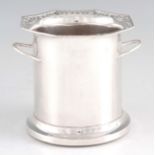 A GEORGE V SILVER MOUNTED WINE BOTTLE HOLDER with wood base, pierced edge and shaped side handles,