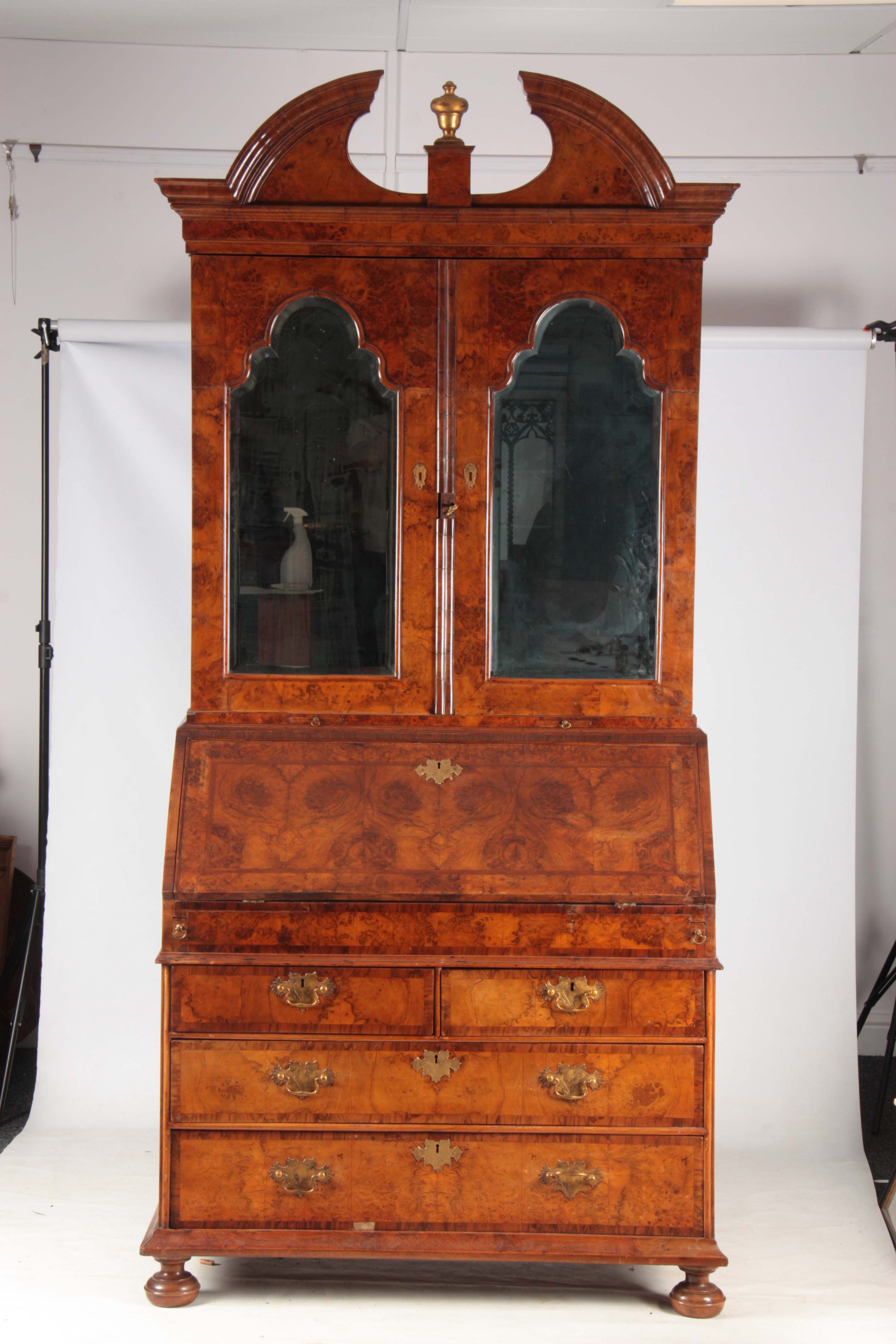 A WILLIAM AND MARY BURR WALNUT BUREAU BOOKCASE with broken arch pediment above shaped mirrored doors - Image 3 of 14