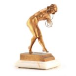 CLAIR JEANNE ROBERTO COLINET. A FRENCH ART DECO GILT BRONZE FIGURE 'The Magic Rings' modelled as a