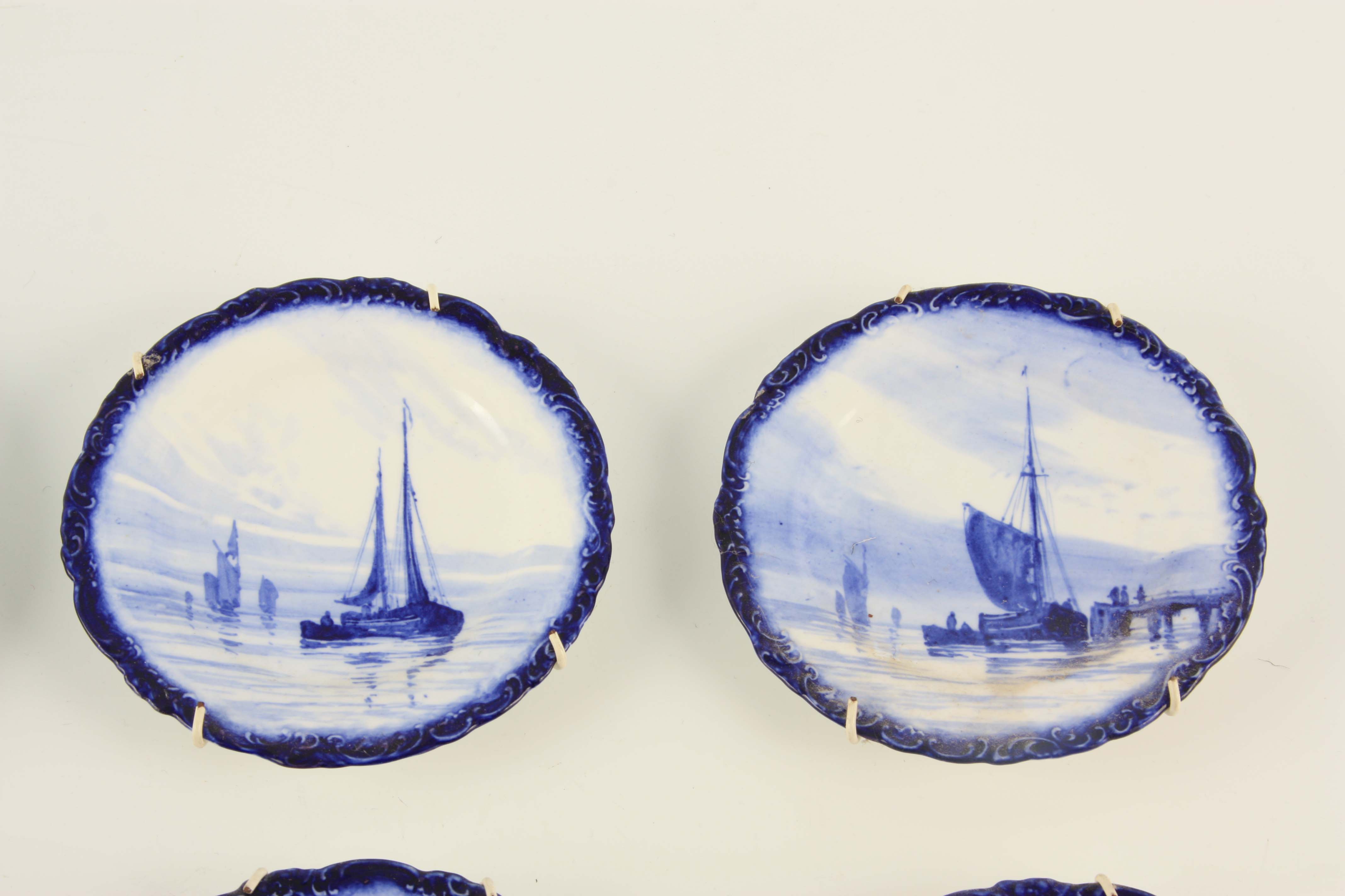 A SET OF EIGHT ROYAL CROWN DERBY SMALL HANGING PLATES painted with differing sailboats on a blue - Image 4 of 9