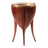 AN EDWARDIAN MAHOGANY PLANTER with slated body and brass liner, hinged handle and cast brass finial;