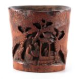 A 19TH CENTURY CHINESE BAMBOO BRUSH POT with carved front depicting figures under a pagoda 15cm