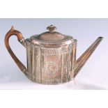 A GEORGE III SILVER TEAPOT of oblate fluted form with engraved borders and cartouche, pointed spout,