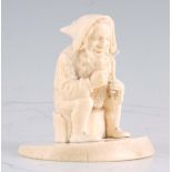 A 19TH CENTURY GERMAN CARVED IVORY SCULPTURE modelled as a smiling gnome sitting on a tree stump