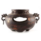 AN EARLY BRONZE CENSER with pierced top rim and bulbous body having dragon mask and loop side