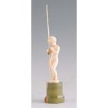 FERDINAND PRIESS. AN ART DECO CARVED IVORY FIGURE modelled as a naked fisherboy holding a rod