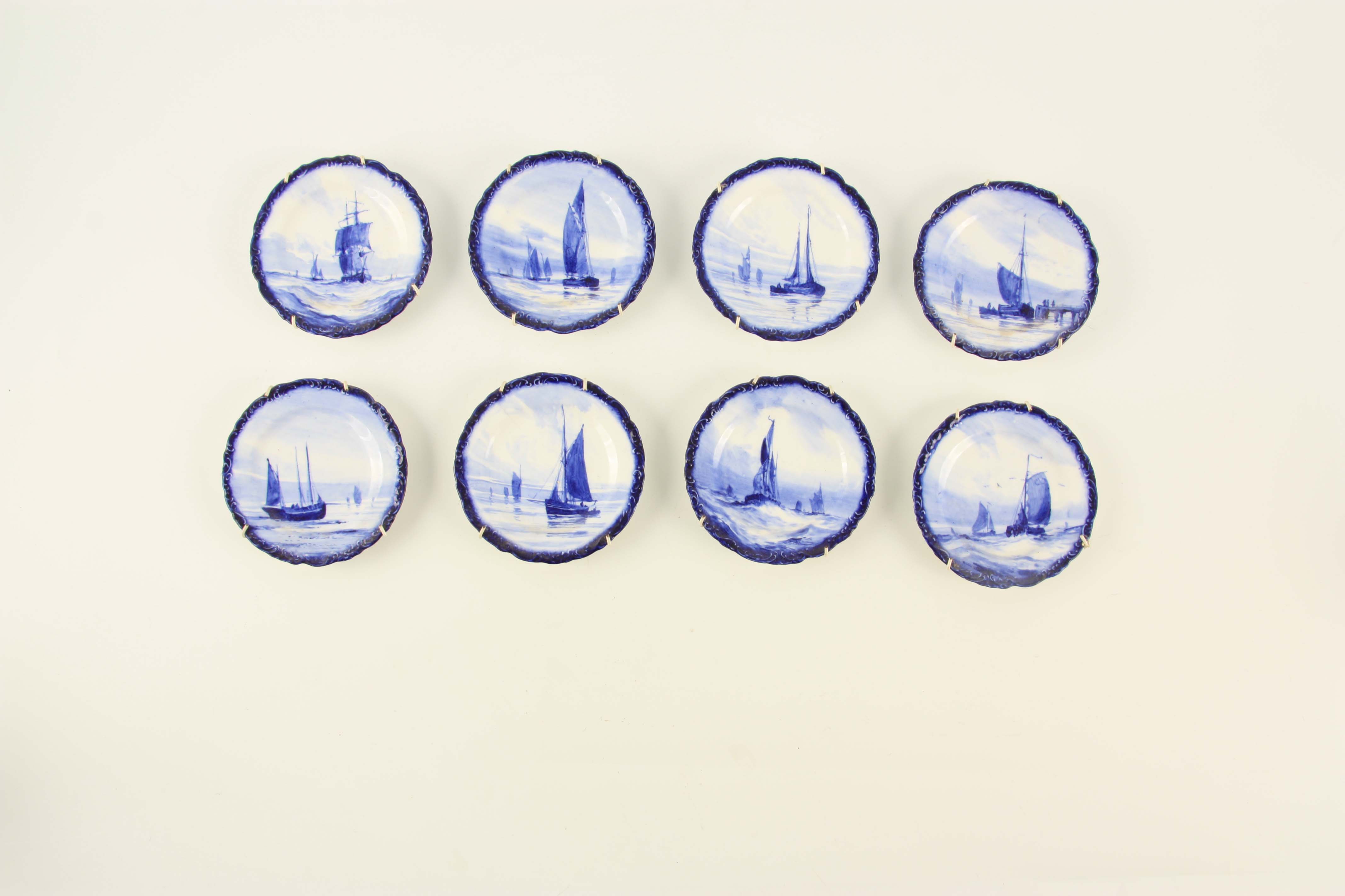 A SET OF EIGHT ROYAL CROWN DERBY SMALL HANGING PLATES painted with differing sailboats on a blue - Image 2 of 9