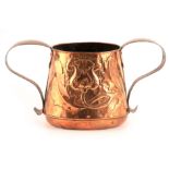 AN ARTS AND CRAFTS TWO HANDLED COPPER JARDINIERE with embossed and planished stylized floral