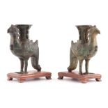 AN EARLY PAIR OF CHINESE PATINATED BRONZE SPILL VASES MODELLED AS BIRDS with detailed decoration