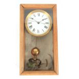 AN ELECTRIQUE BRILLIE ELECTRIC MAGNETIC MASTER CLOCK housed in an oak case enclosing a 6"