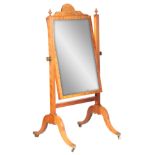 A REGENCY FIGURED SATINWOOD CHEVAL MIRROR IN THE MANNER OF GILLOWS with adjustable swivelling mirror
