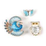TWO SILVER GILT AND ENAMEL BROOCHES BY DAVID ANDERSON modelled as an exotic bird measuring 5cm high,