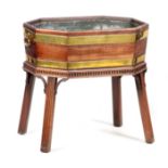 A GEORGE III MAHOGANY CHIPPENDALE STYLE WINE COOLER with brass-bound octagonal shaped top fitted