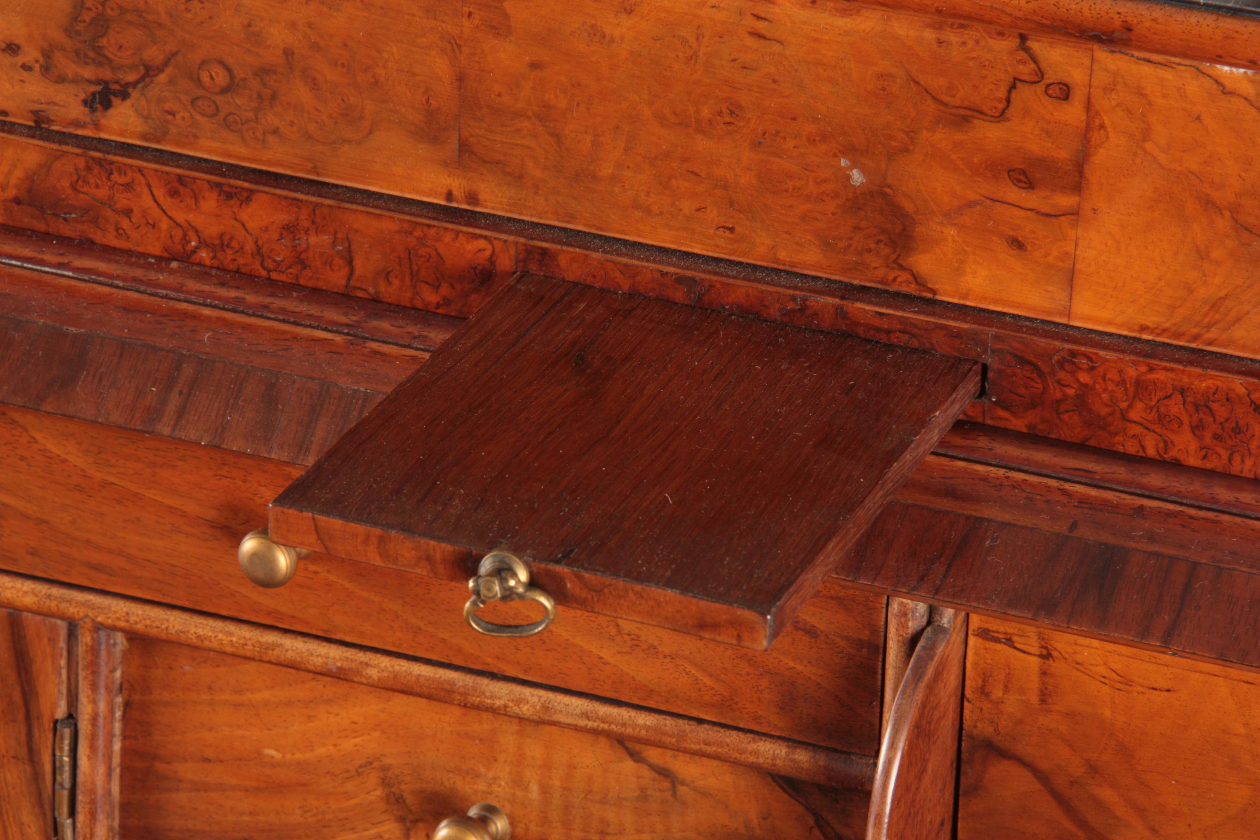 A WILLIAM AND MARY BURR WALNUT BUREAU BOOKCASE with broken arch pediment above shaped mirrored doors - Image 9 of 14