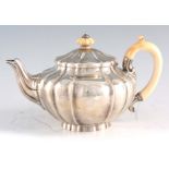 A VICTORIAN SILVER AND IVORY TEAPOT of squat bulbous design with ivory finial and handle 14.5cm